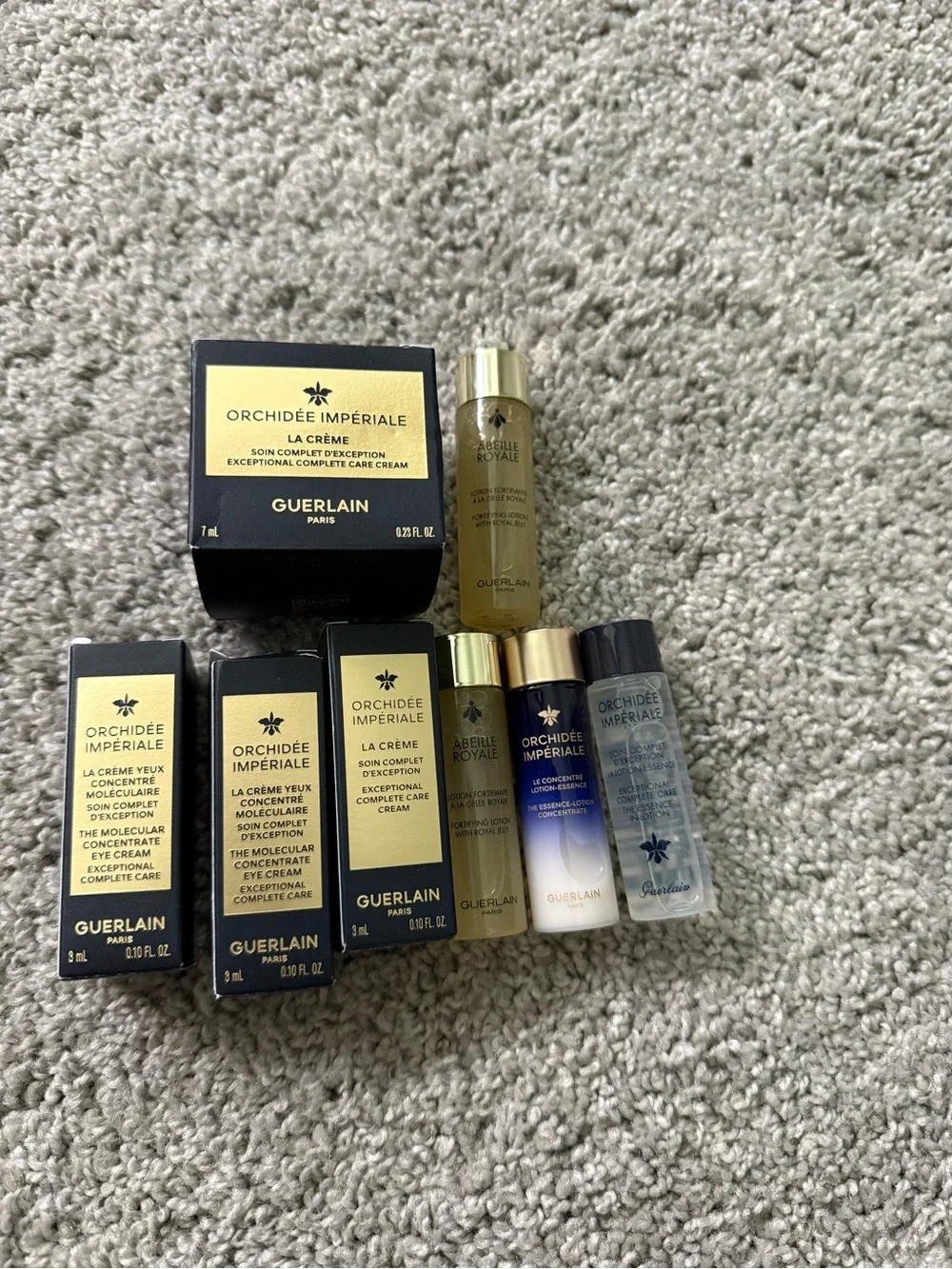 GUERLAIN gold and cream skincare set with woven clutch